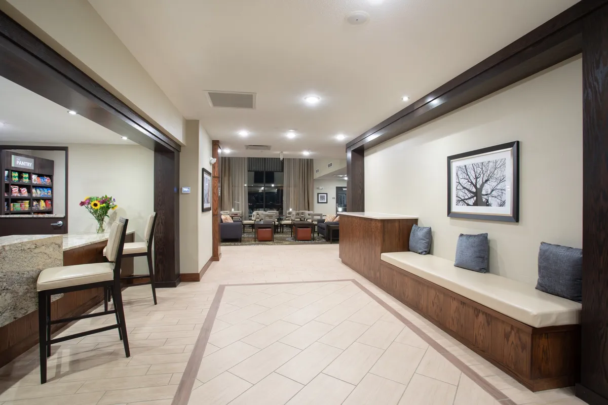 This image features a welcoming interior space with a counter stocked with snacks, a comfortable seating area, and framed artwork on the walls. The casual setting suggests a spot where families can gather, relax, and enjoy refreshments after a day of local adventures.